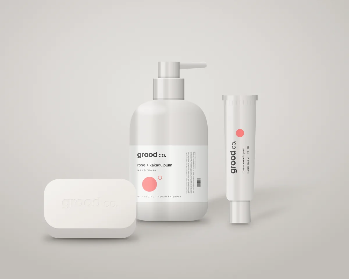 Grood Co. hand wash, hand balm and body bar in white packaging on a grey studio backdrop